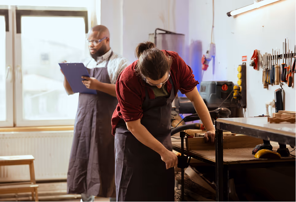 A man and a woman working in a shop.