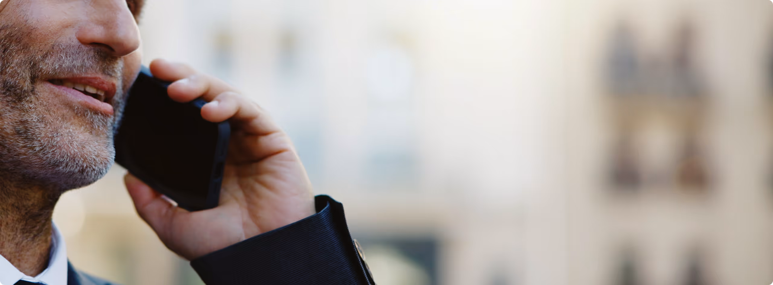 A close up of a person talking on a cell phone.