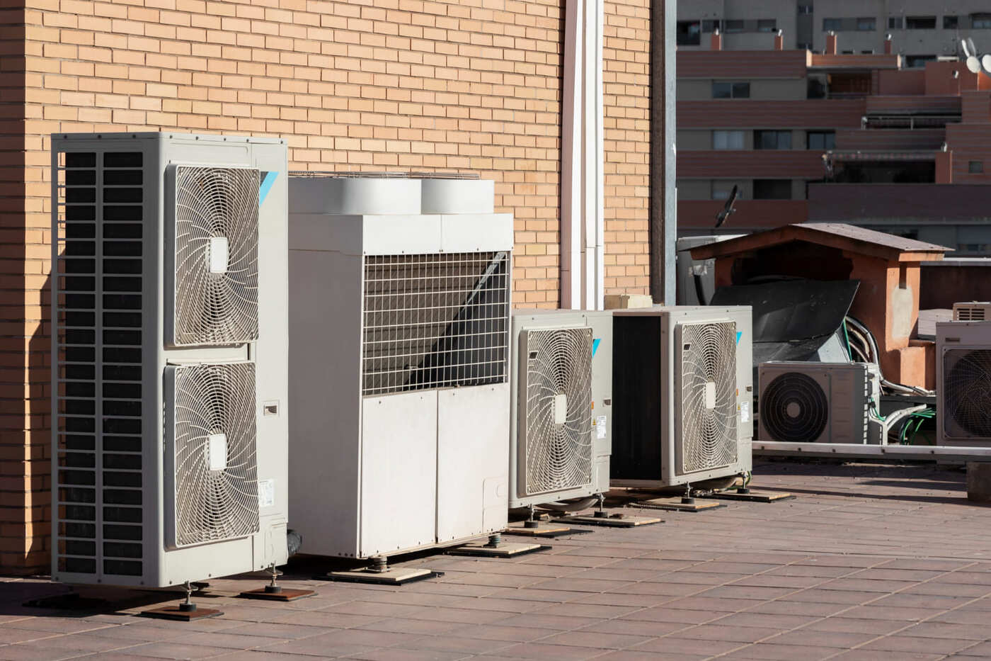Des unités de pompe à chaleur et de systèmes de ventilation sont côte à ctte collées à un mur