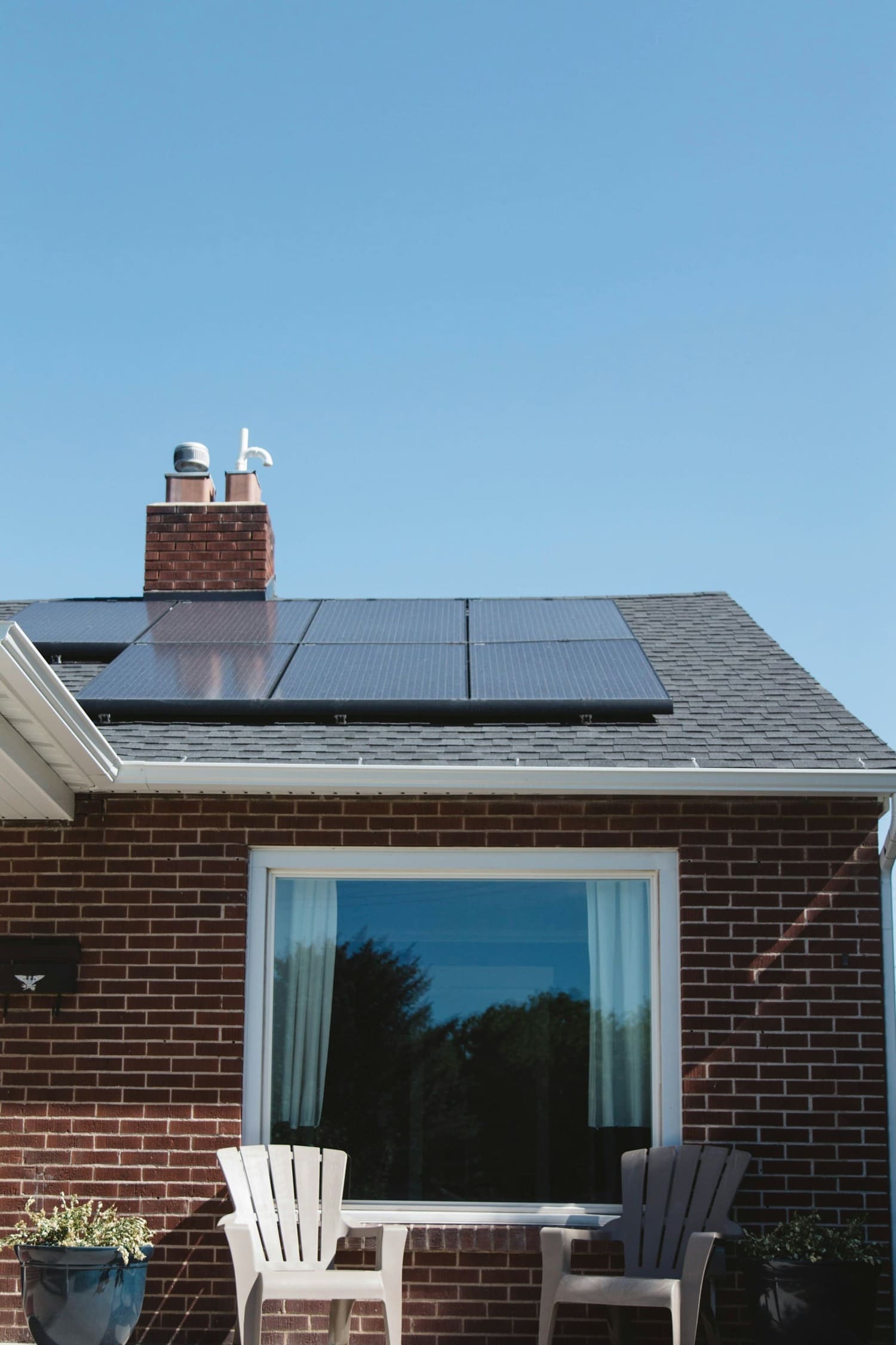 Maison en brique rouge avec des panneaux solaires sur le toit