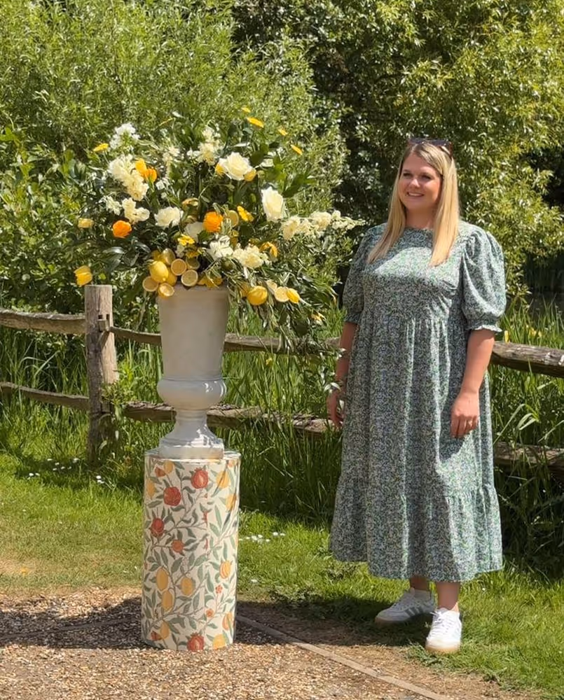 Maddy Shutes next to flowers outside