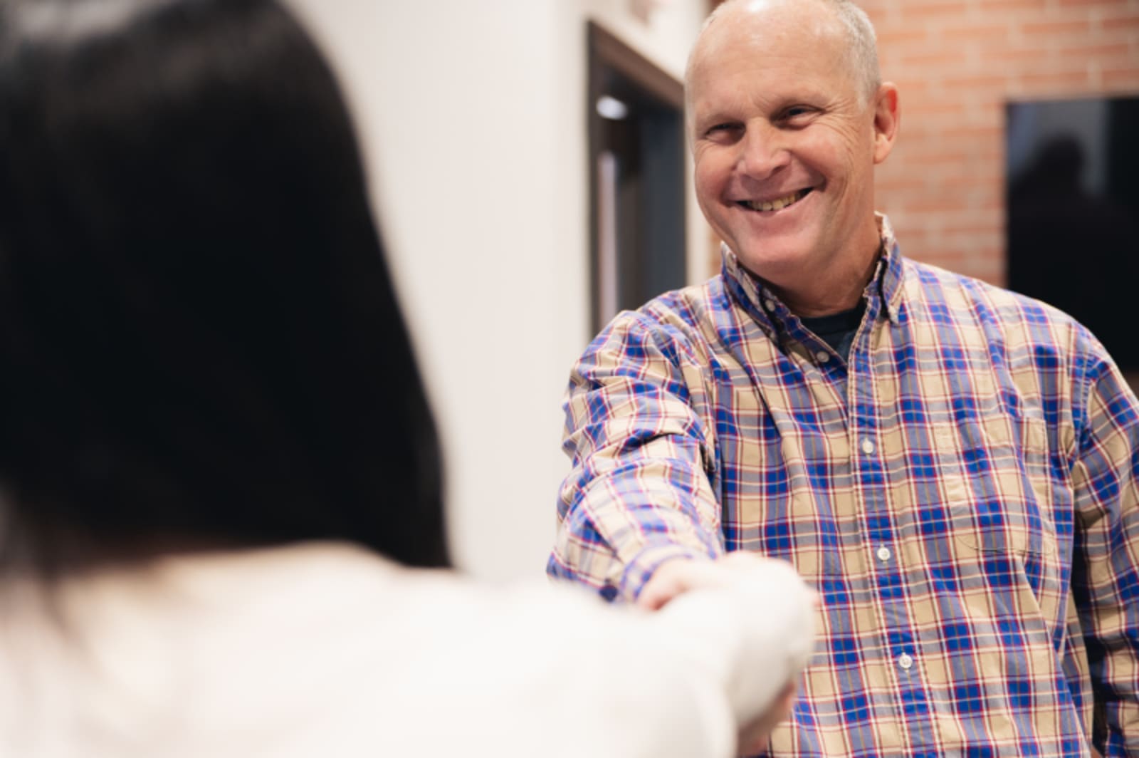 Male patient conversing with female receptionist, building rapport and trust during consultation