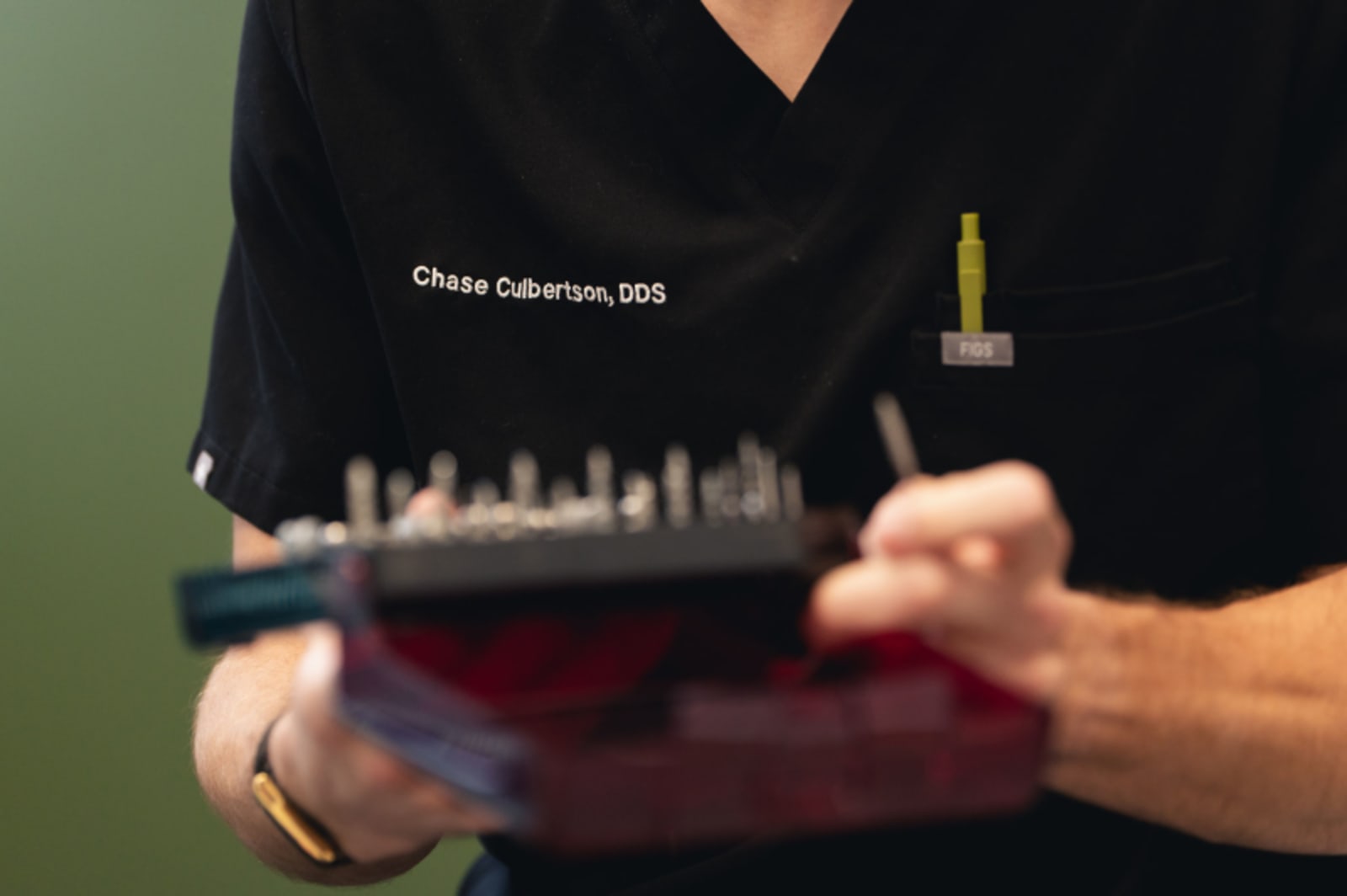 Dentist holding dental model showing tooth structure and veneer placement