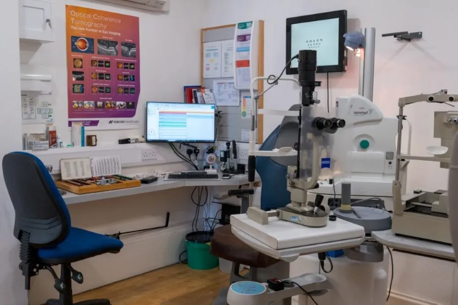 Ophthalmology exam room with eye examination equipment and computer screens