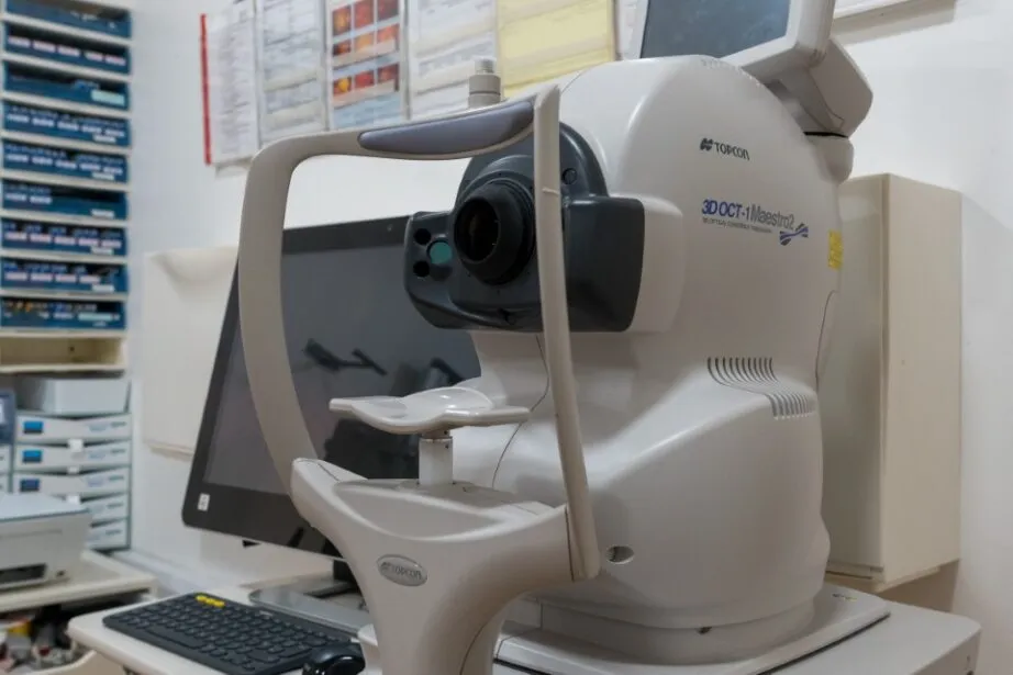 Medical eye exam machine in clinical setting with computer and keyboard