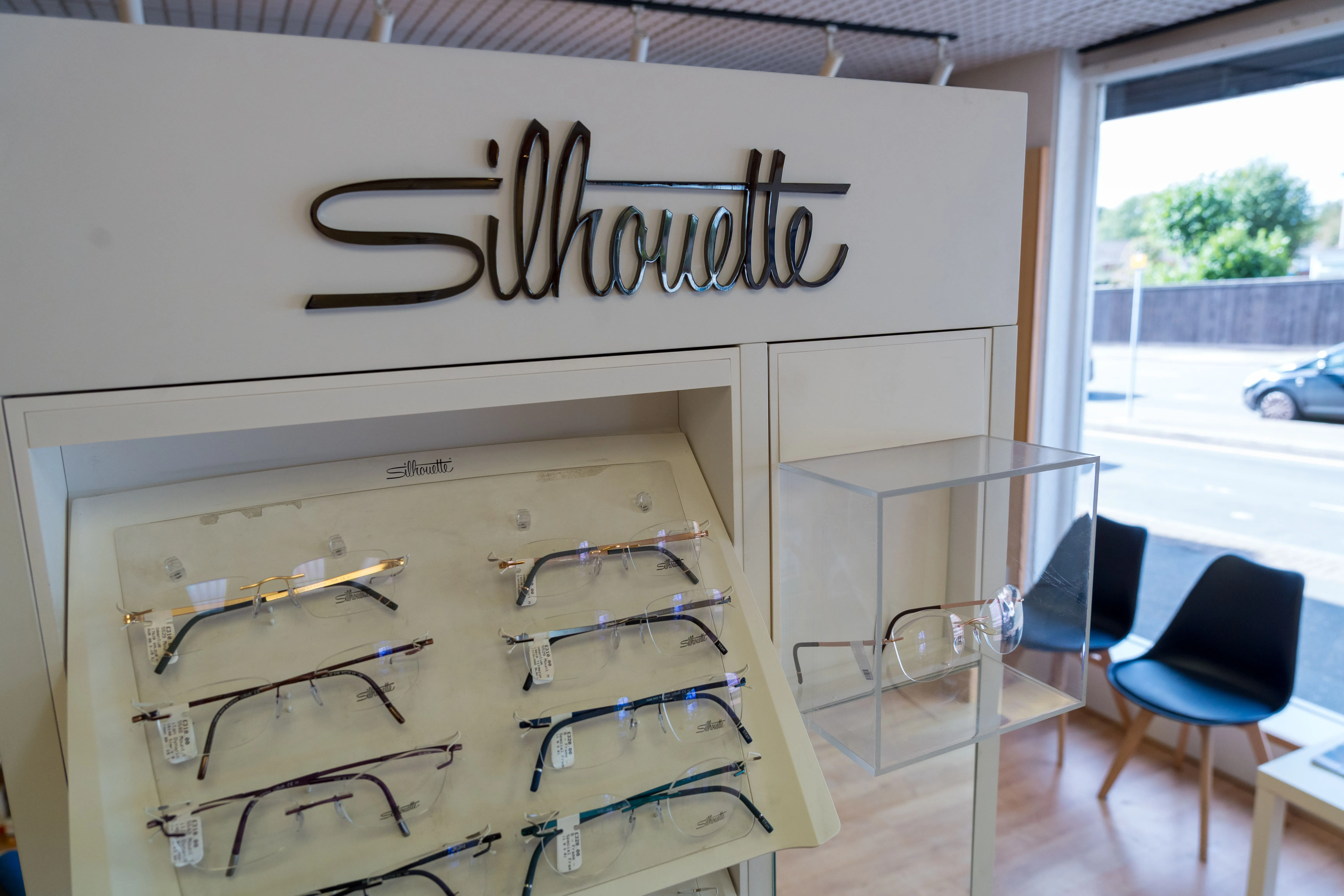 Silhouette eyeglasses display in optical store with various rimless frames