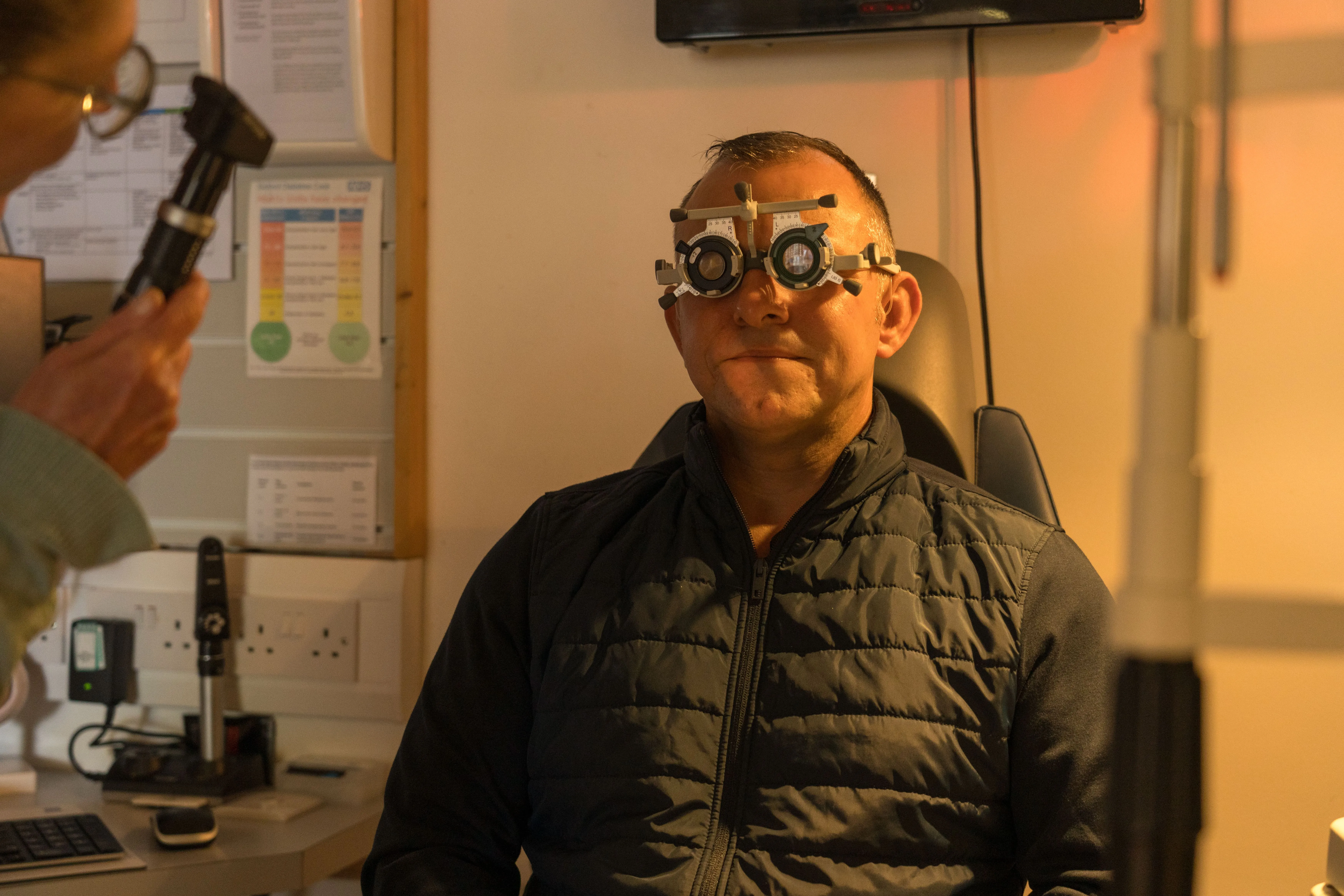 Patient wearing eye exam equipment during vision test in medical office