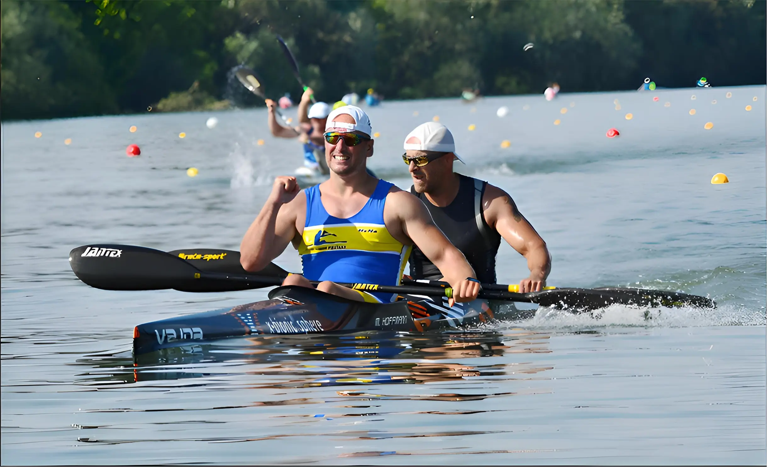Two men in a double kayak celebrating while paddling on a calm river during a race.
