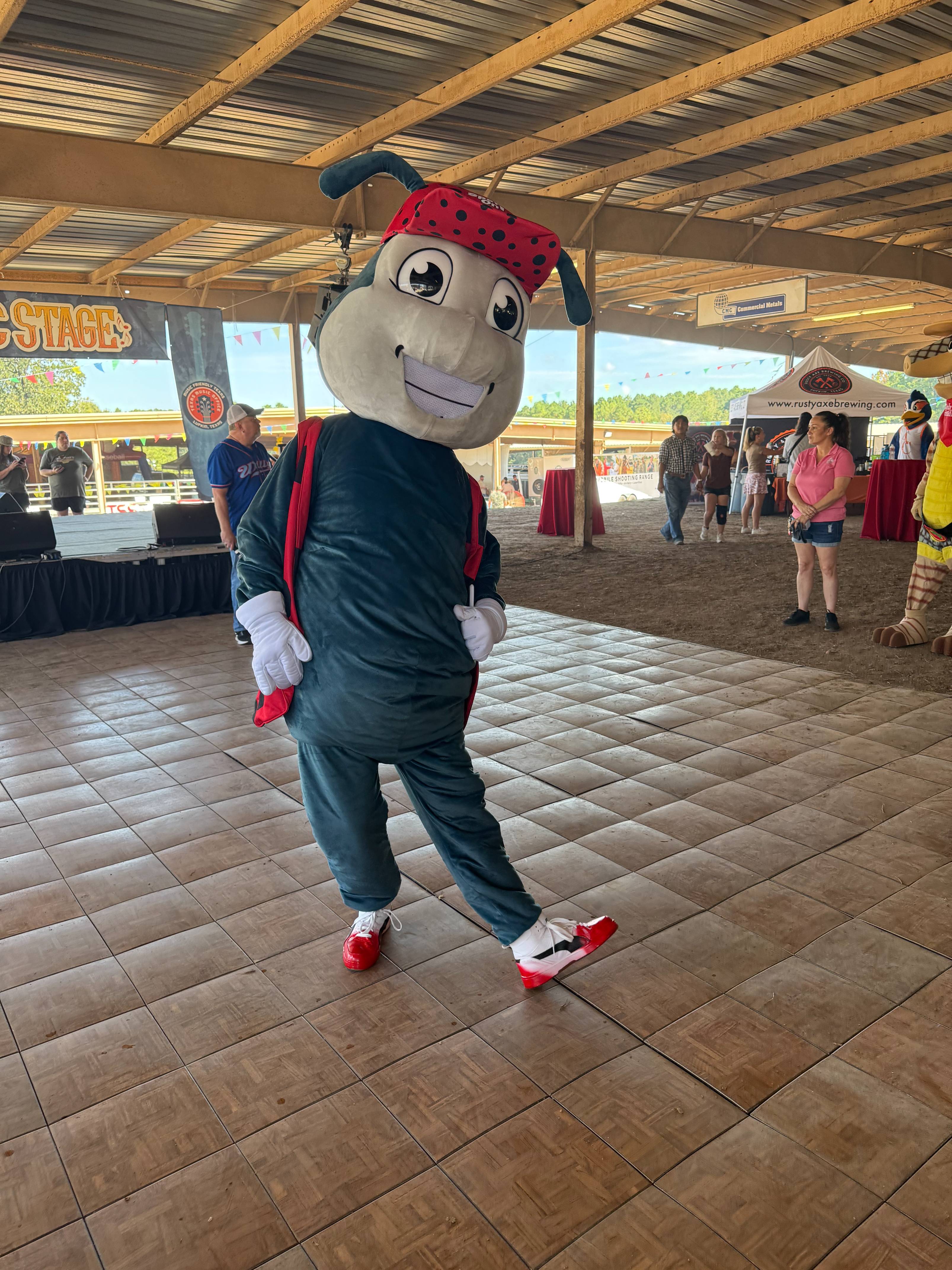 Ladybug mascot posing on a stage.