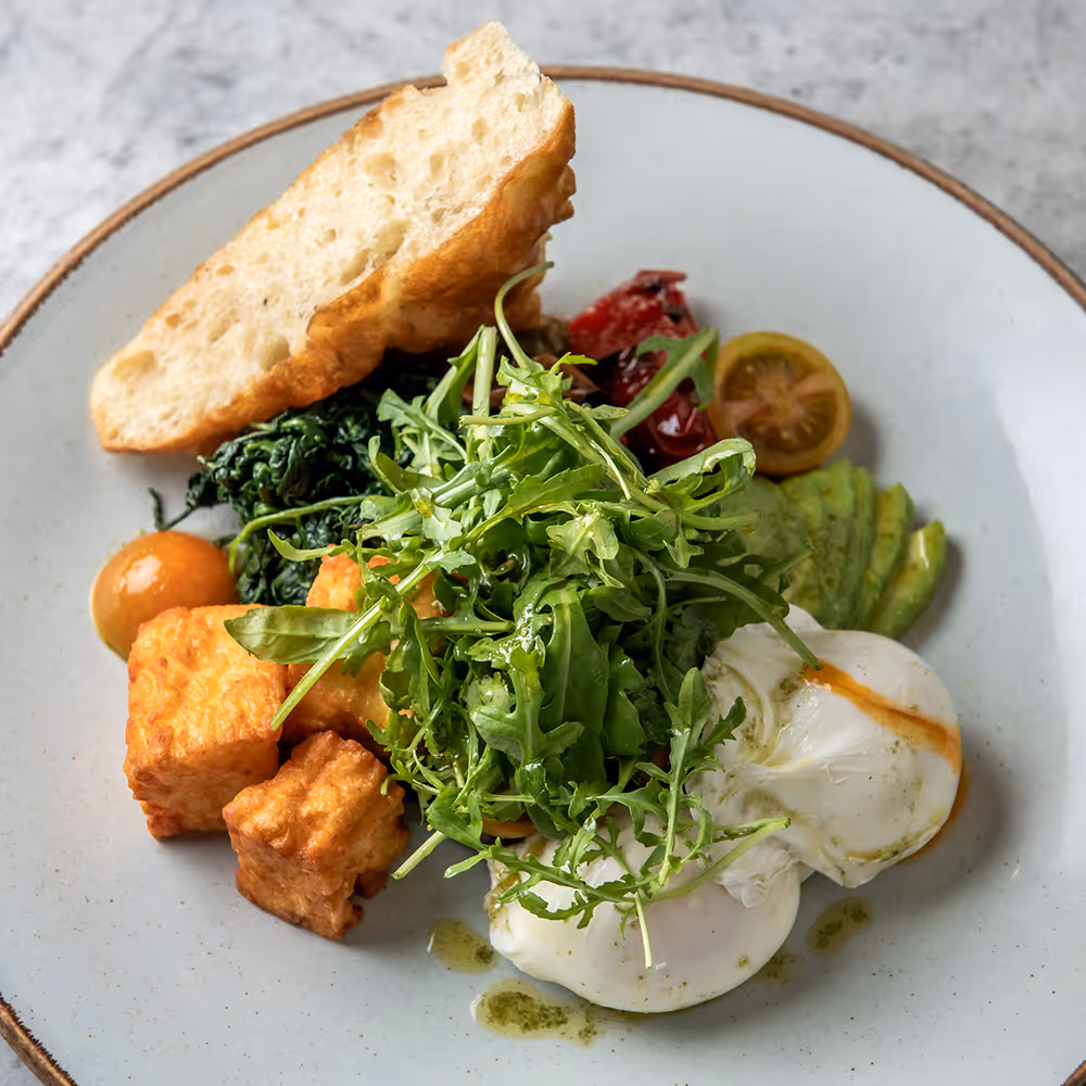 Fego Cafe Full Mediterranean breakfast with poached eggs, halloumi, peppers, mushroom, avocado, spinach, rocket, harissa tomato & focaccia