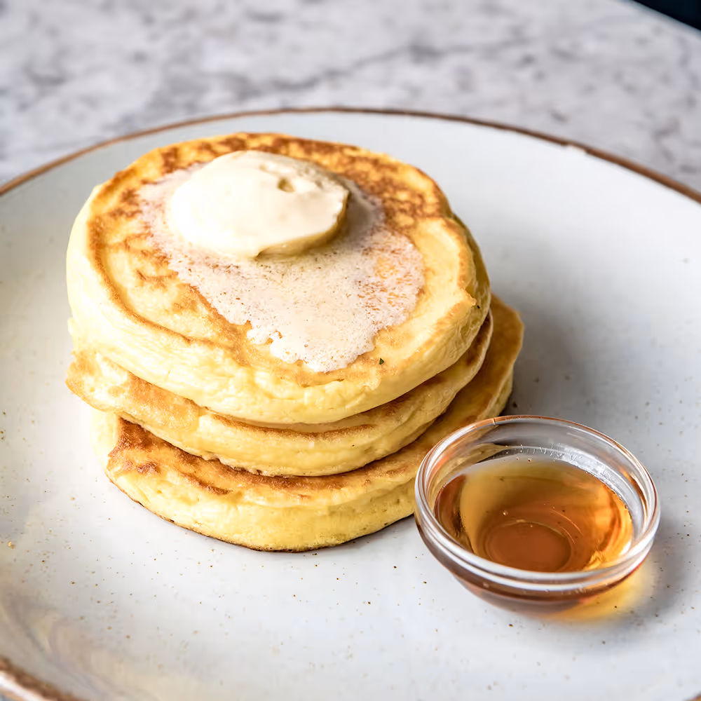 Fego Cafe pancakes On Their Own with 3 buttermilk pancakes, maple butter & maple syrup