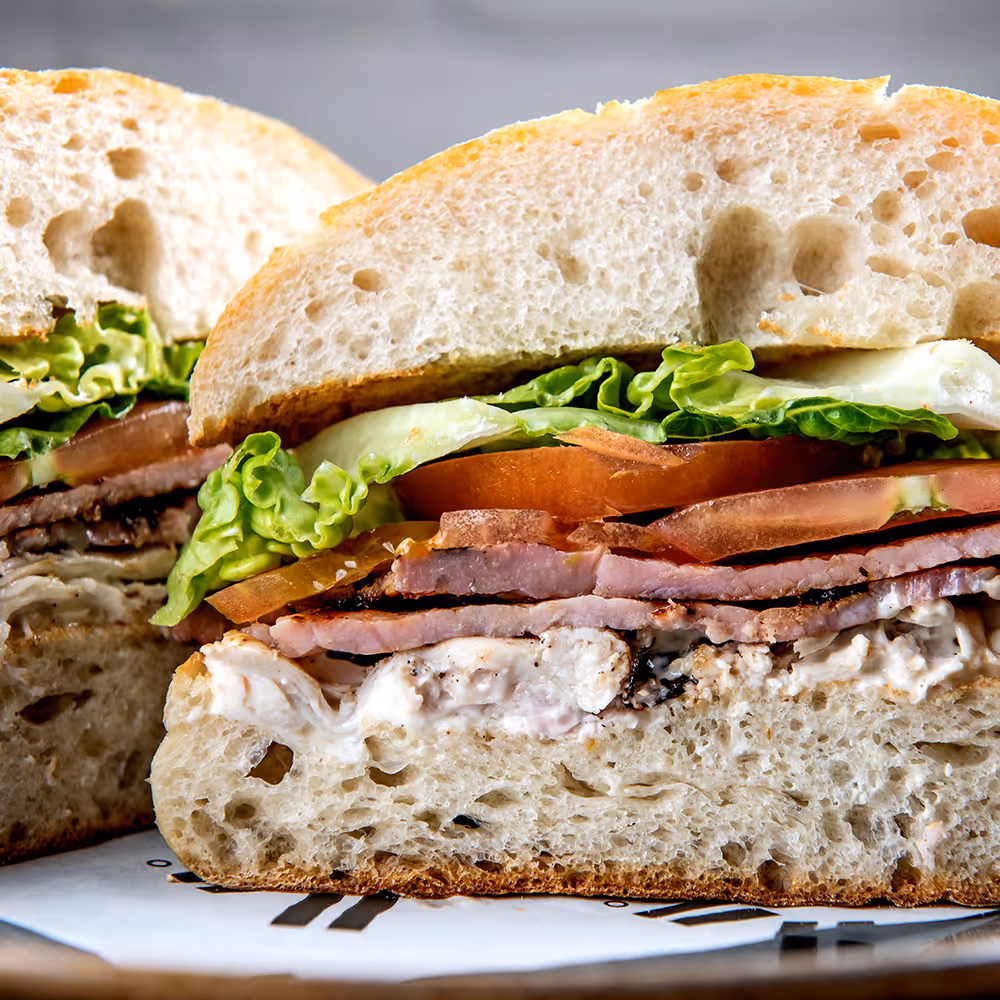 Fego Cafe Fego Club Ciabatta with pulled chicken, bacon, smashed avocado, tomato, mayonnaise & gem