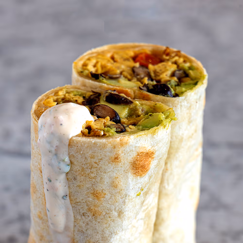 Fego Cafe Breakfast Burrito with black beans, avocado, jalapeños, egg, cheddar, peppers & harissa tomato