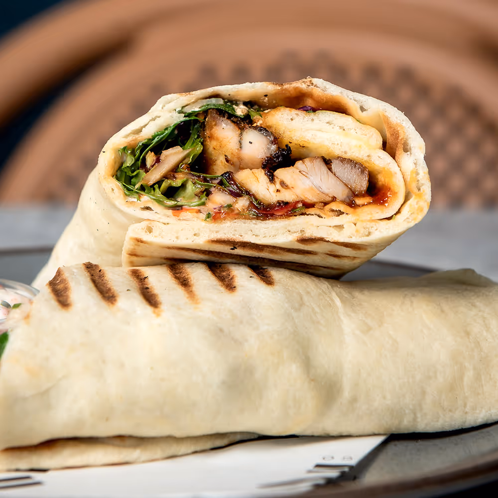 Fego Cafe Crunchy Chicken Wrap with breadcrumbed chicken fillets, gem, tomato, cheddar cheese, salsa & sweet chilli