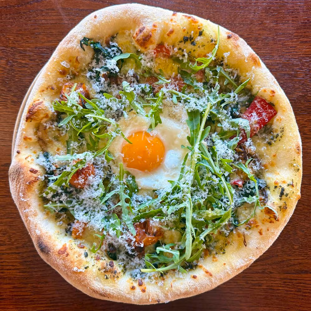 Fego Cafe Mediterranean sourdough pizza with pesto, spinach, wild mushrooms, peppers, harissa tomato, egg, mozzarella