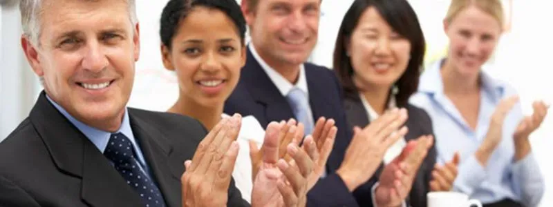 Close up picture of professionals of diverse ethnicities clapping illustrating executive support for advocacy programs.