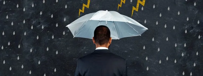 Back of man in a suit holding umbrella with graphic images of lightening and rain surrounding him.