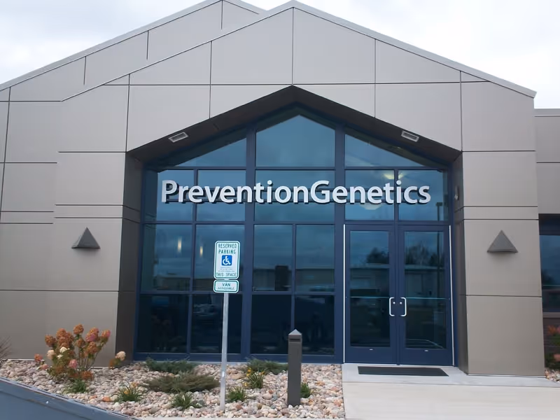 Large glass outdoor building with Prevention Genetics signage solutions