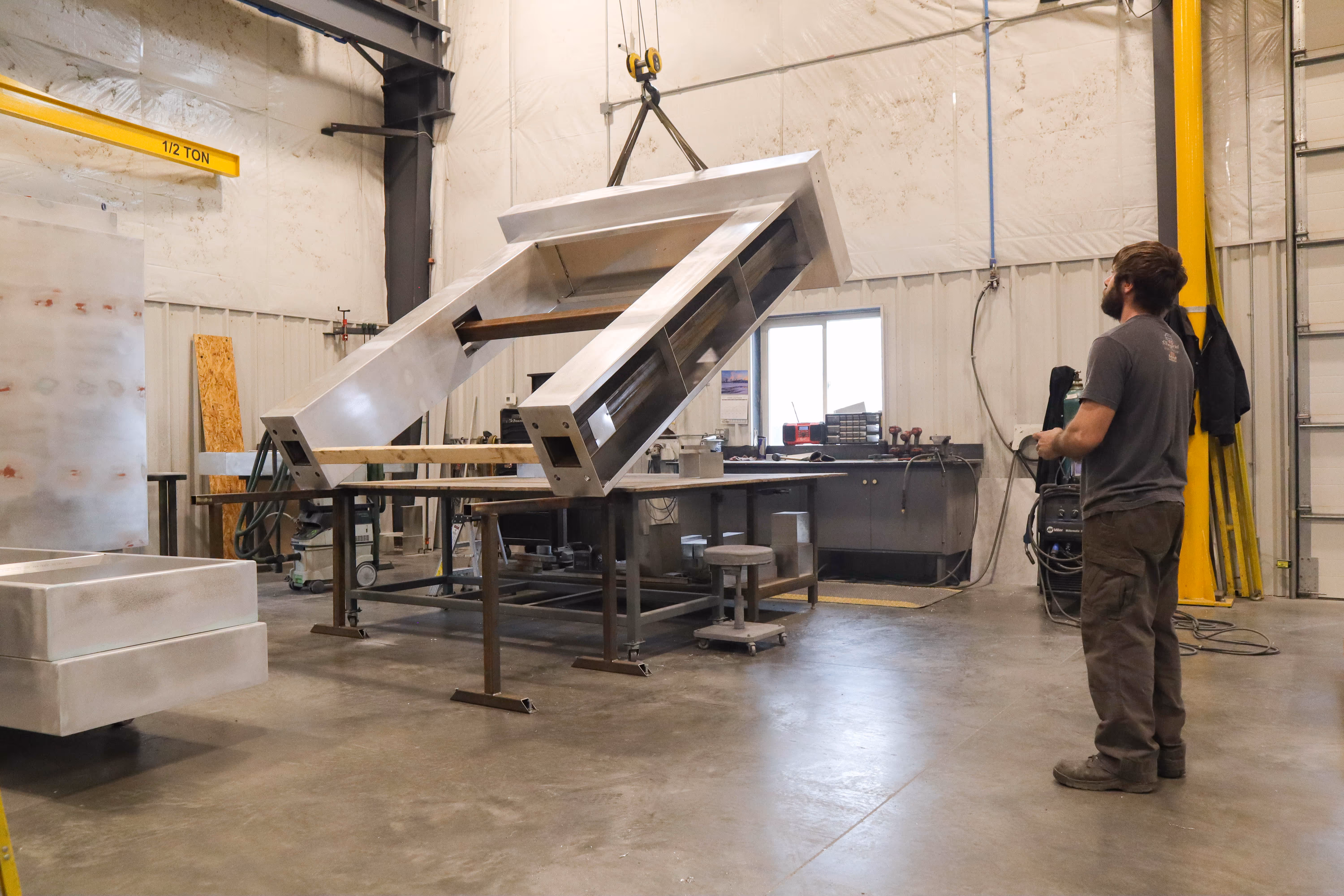 Stratford sign being lifted in the warehouse