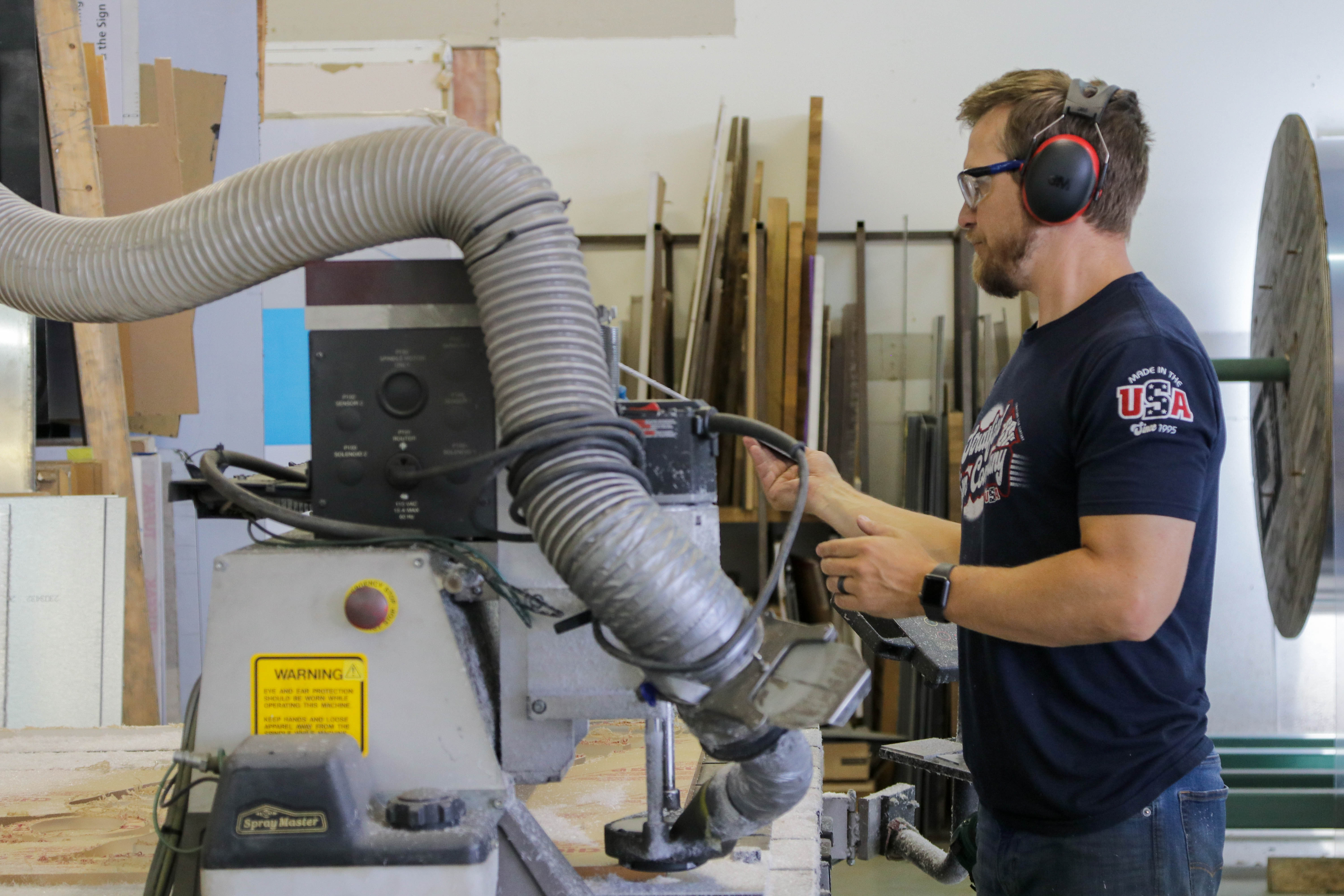 man working at stratford sign co labeling the equipment