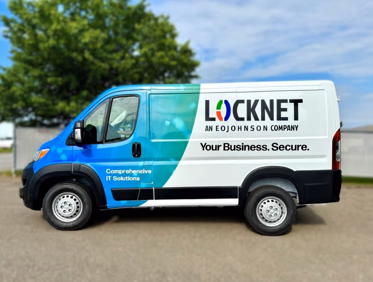 White and blue Locknet company van parked outside with text 'Comprehensive IT Solutions' and 'Your Business. Secure.'