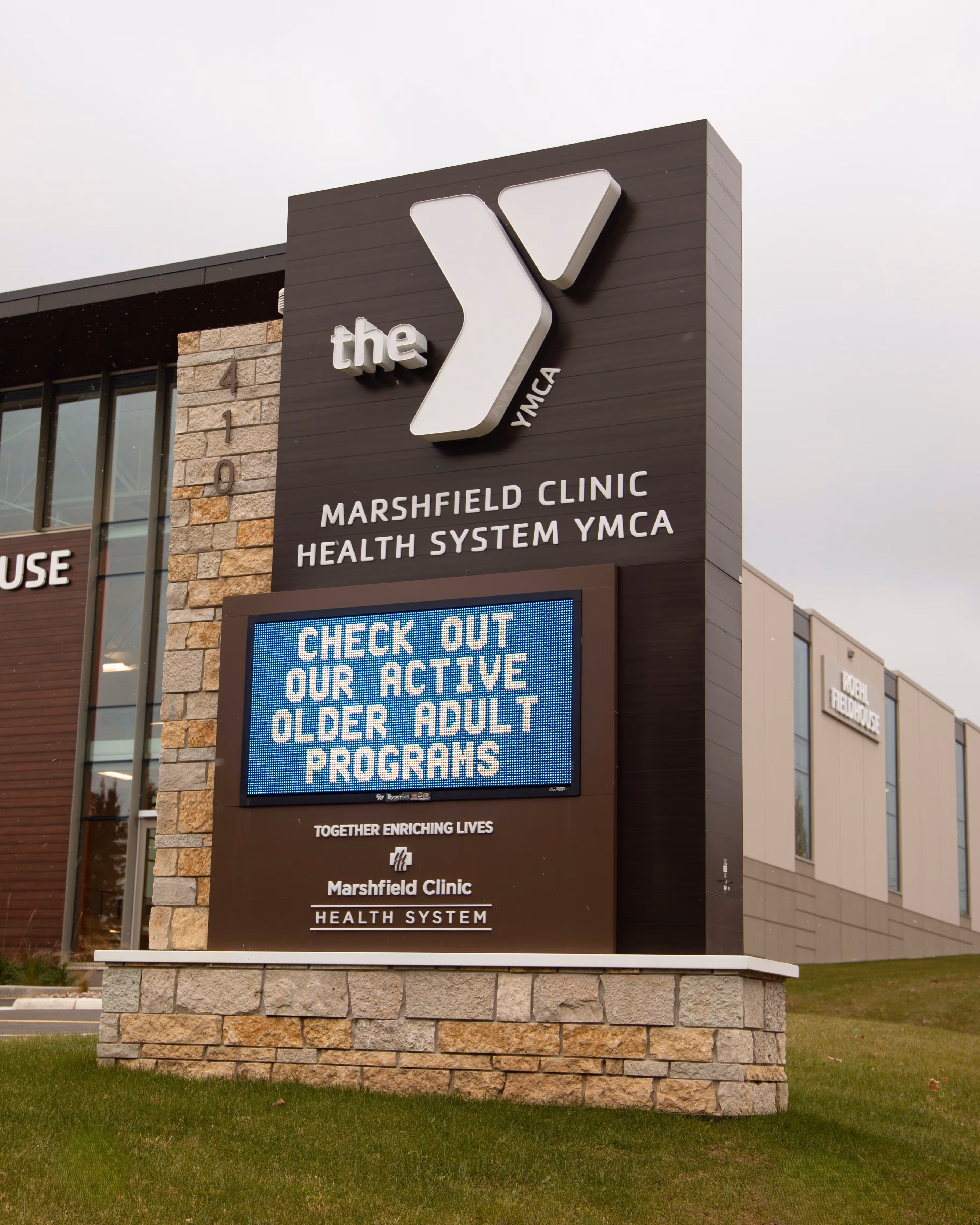 Marshfield Clinic Health System YMCA building sign with electronic display promoting active older adult programs.
