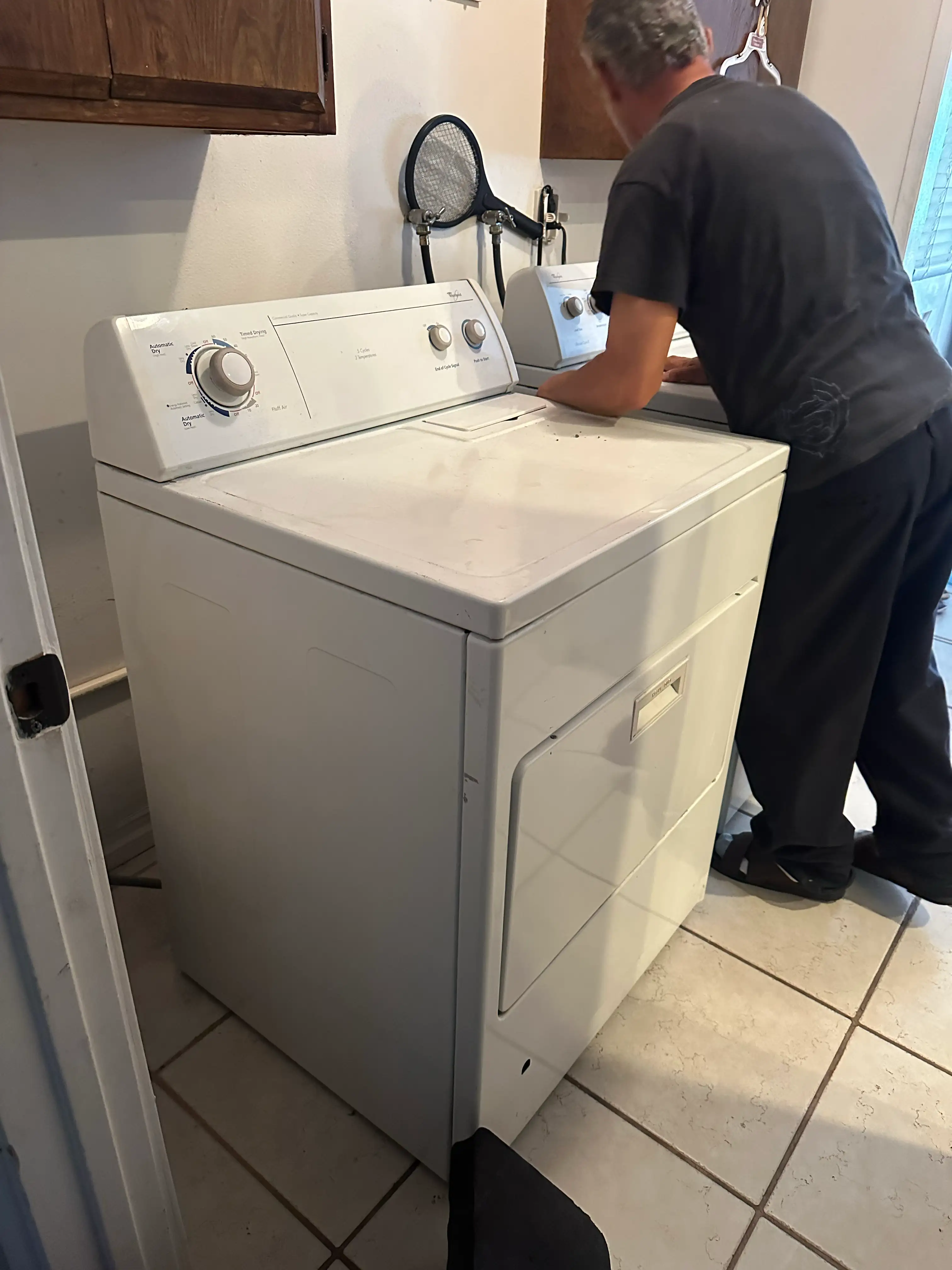 Dryer is repaired by appliance technician