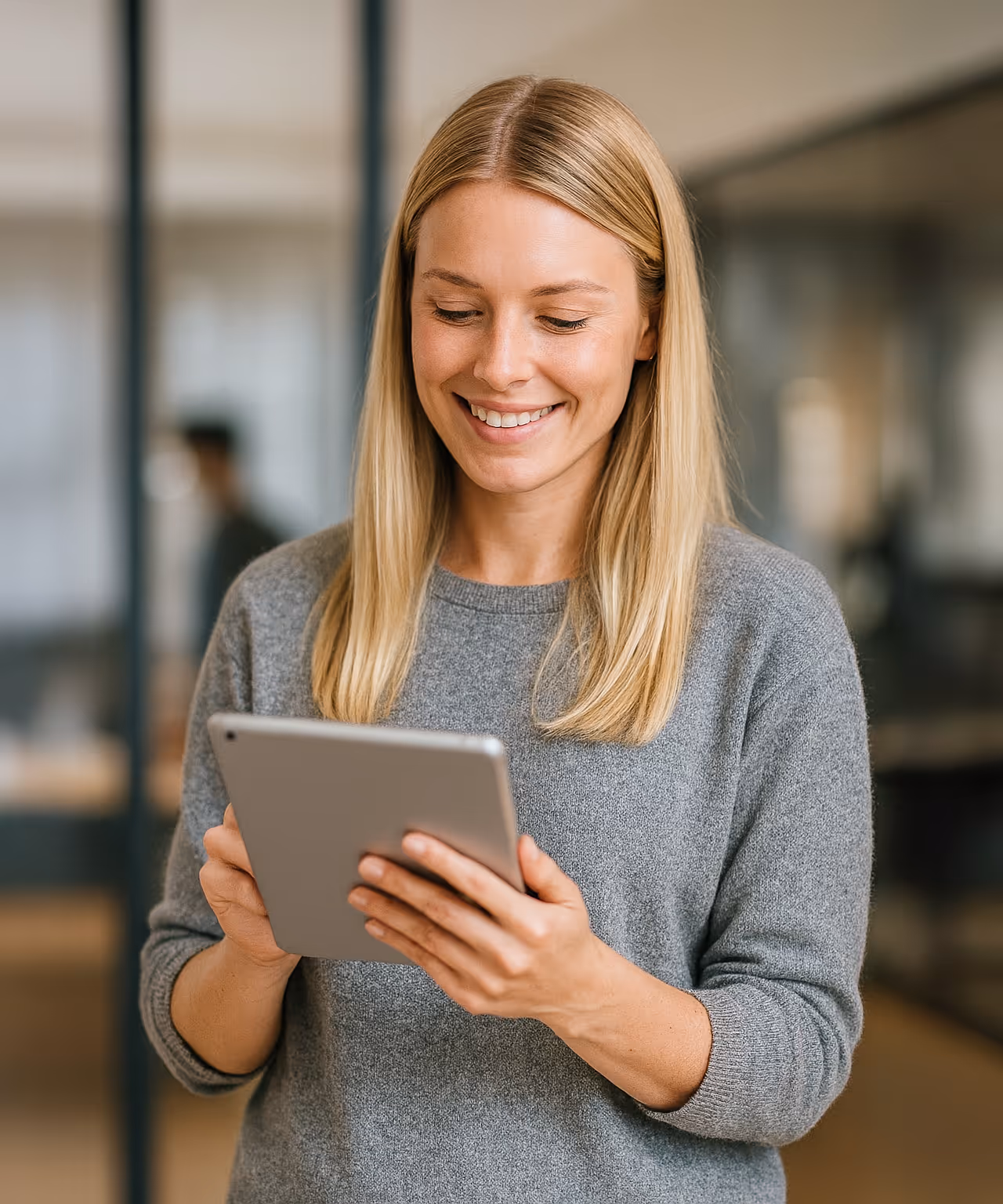 A woman holding here iPad looking at some good charts of new leads coming in
