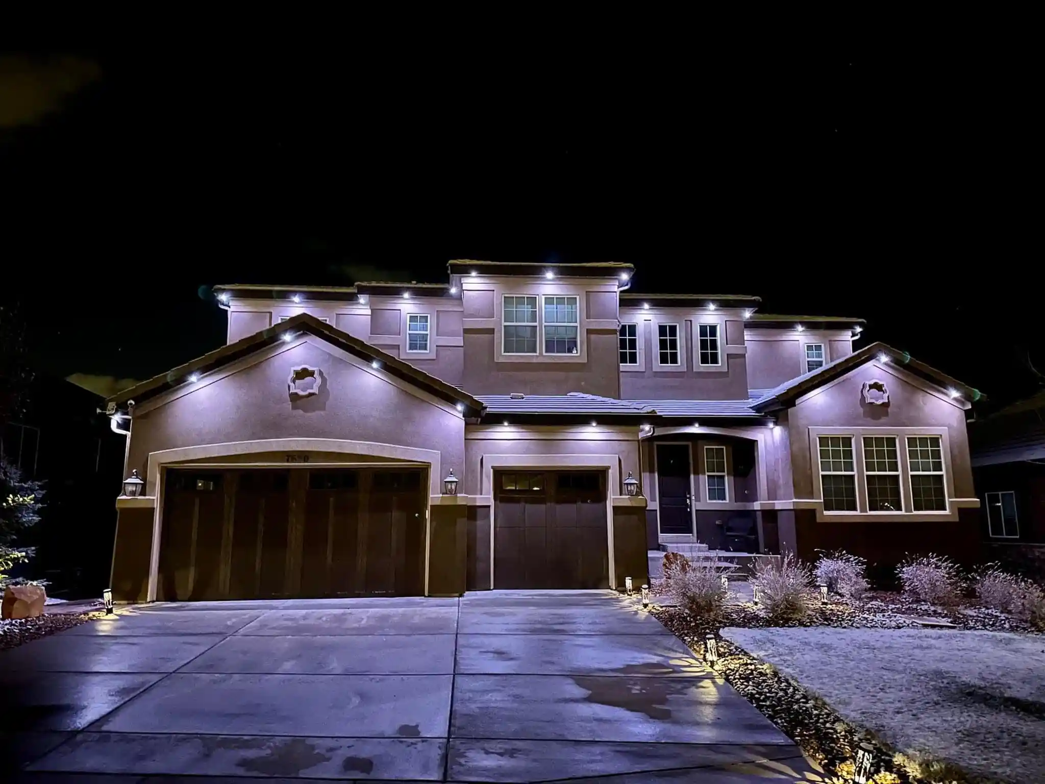 House exterior lit by lights.