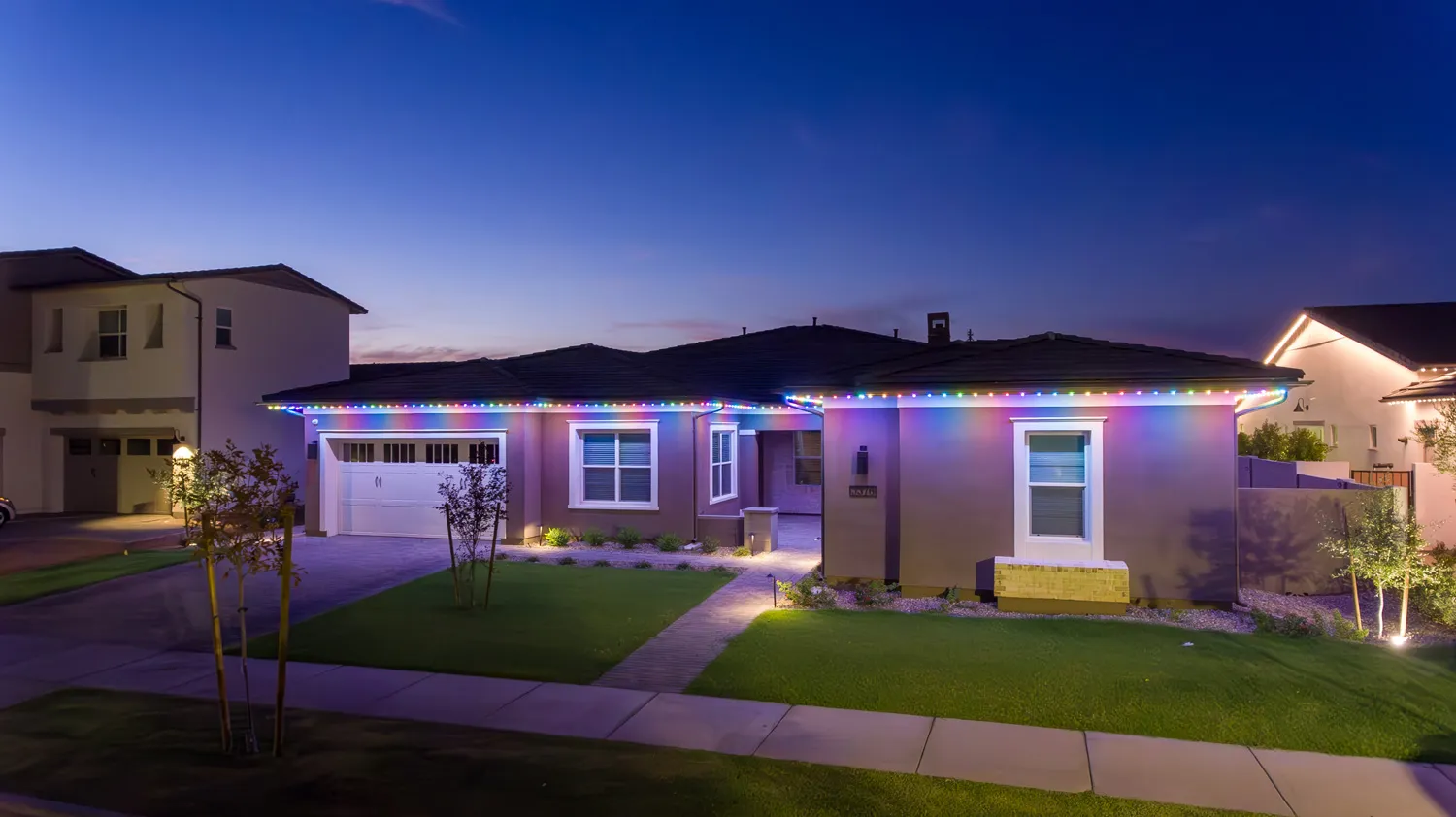 House lit with colorful roof lights.