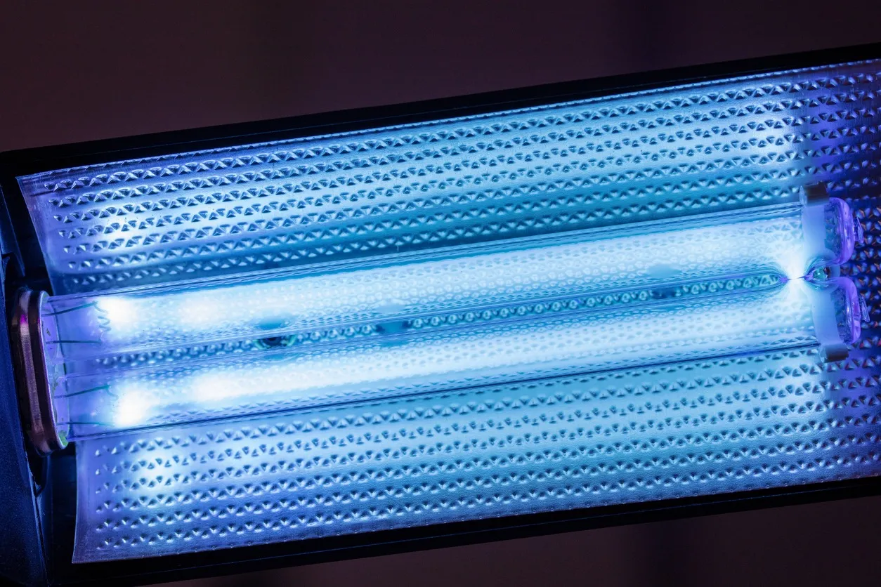 A close-up of a double ultraviolet light bulb with a textured metal housing