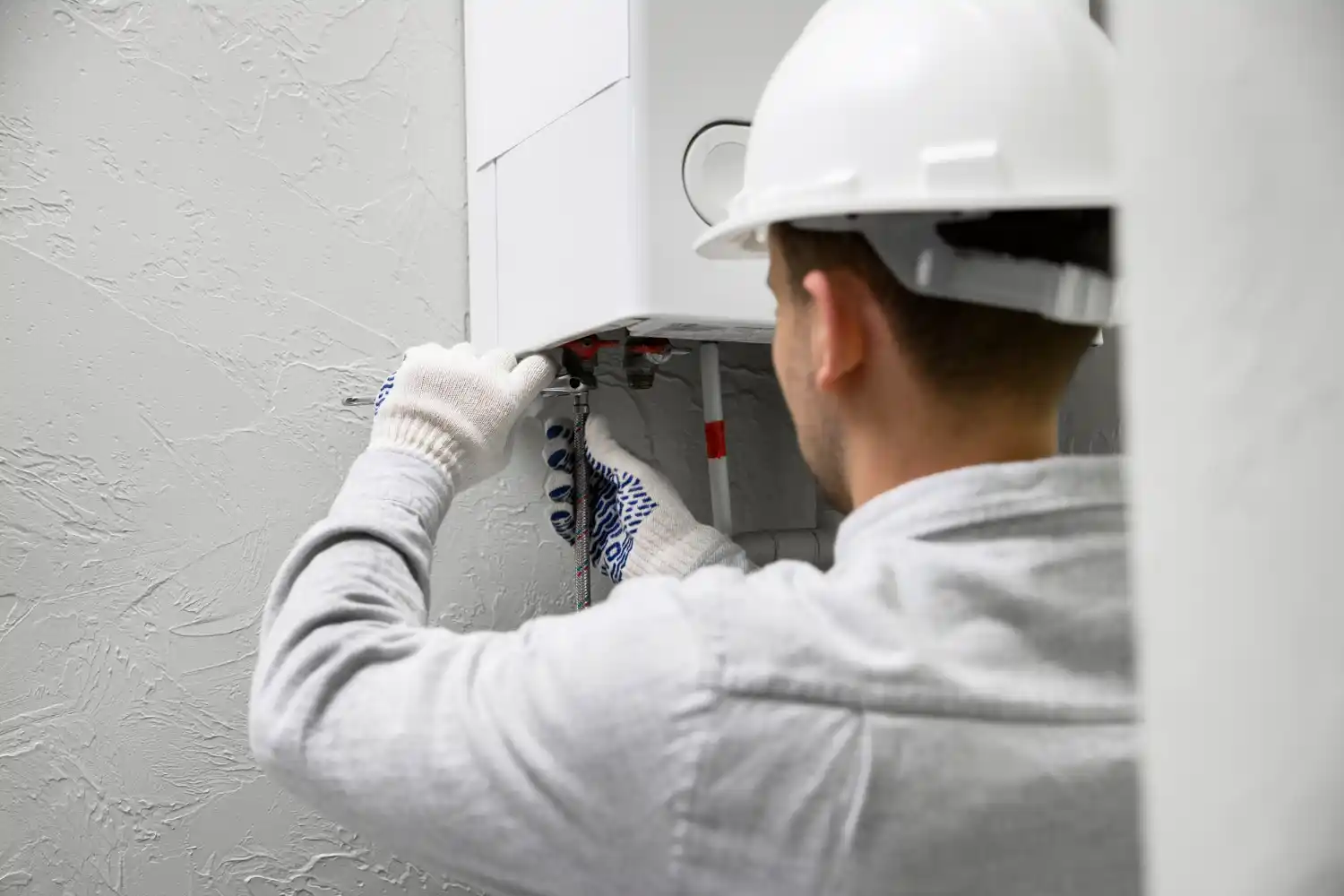 Technician working on tankless water heater.