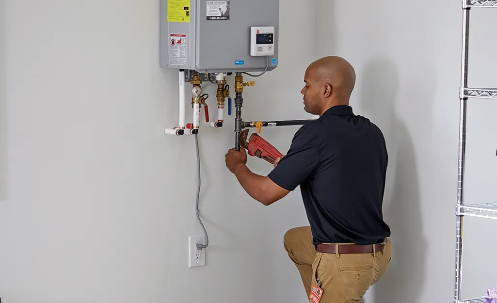 Man replaces a tankless water heater.