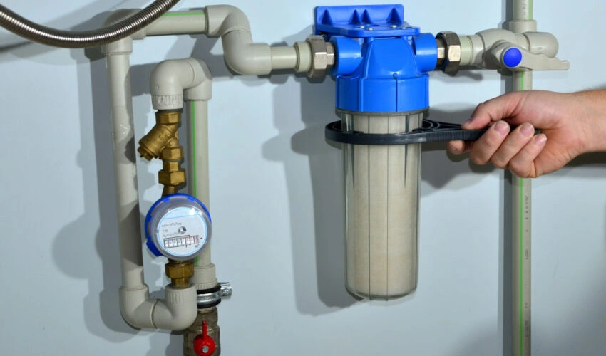 A worker replaces a water filter.