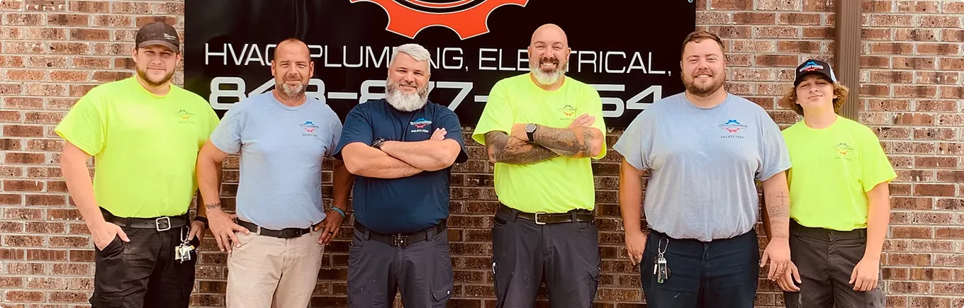 Team members of ServiceWorks Mechanical Solutions pose together, representing the Houston Plumbing Electric team.