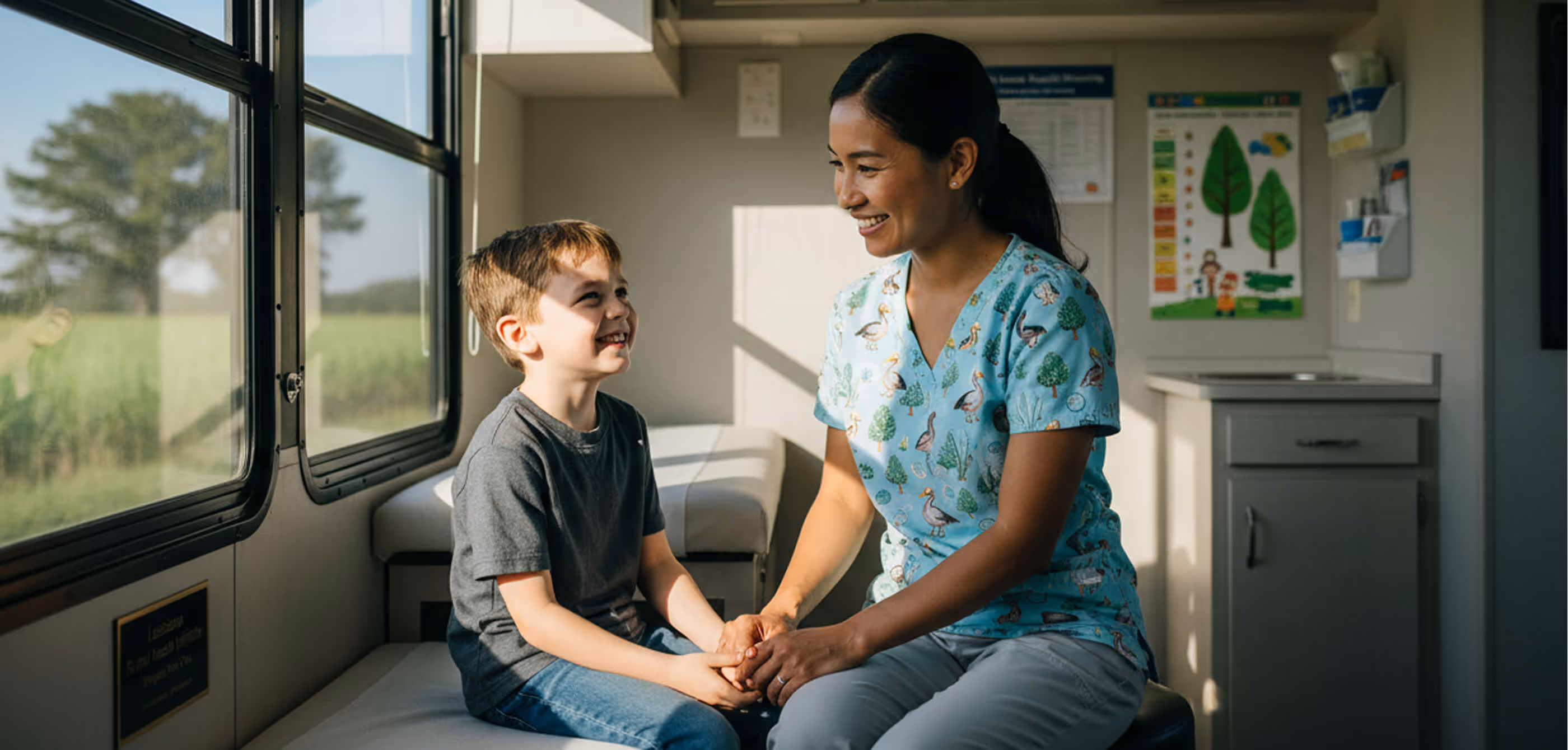 Asian female pediatrician, sitting with young boy in her office.