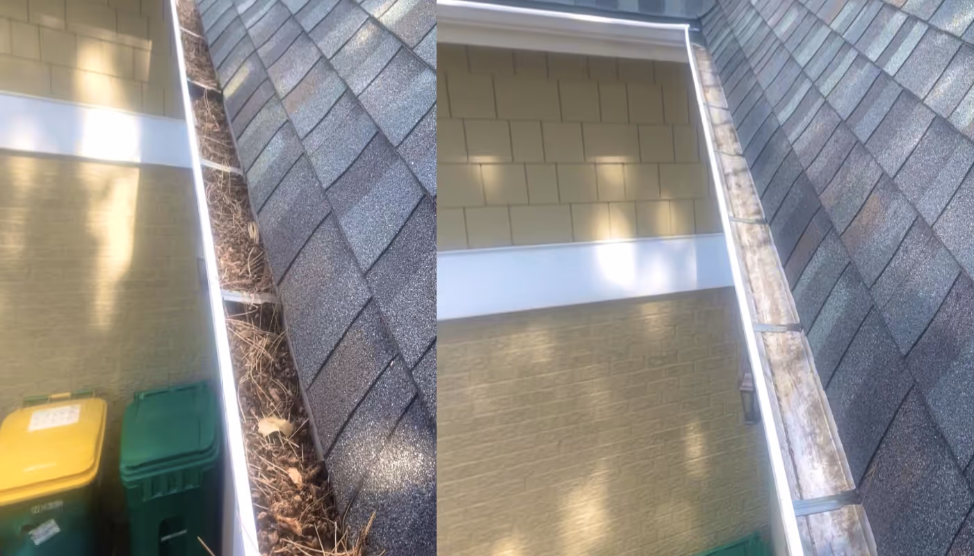 Residential window cleaning technician squeegeeing a two-story home