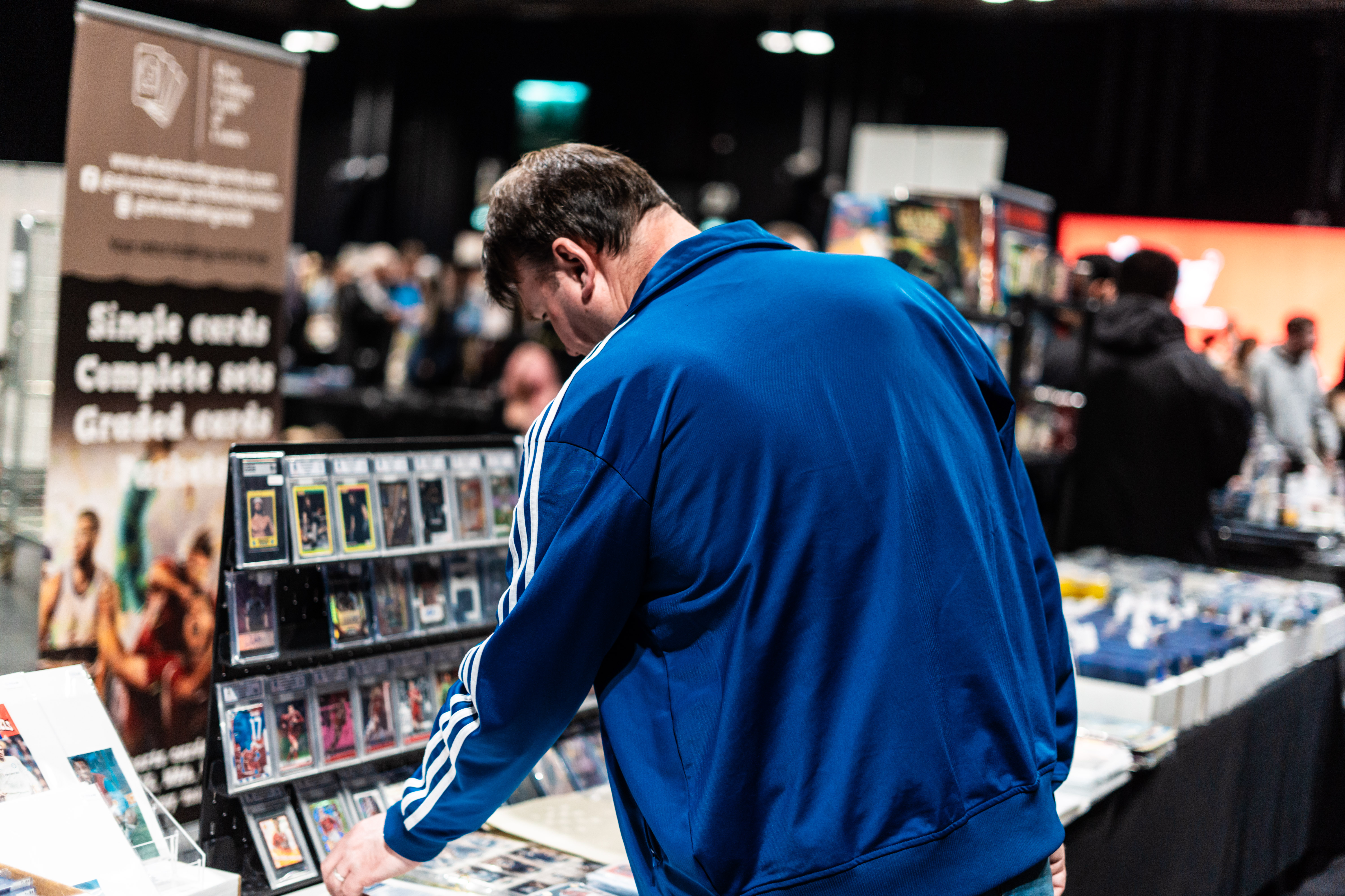 Close-up of collectible trading cards in protective cases on display, including Disney’s Mickey and Minnie Mouse designs.