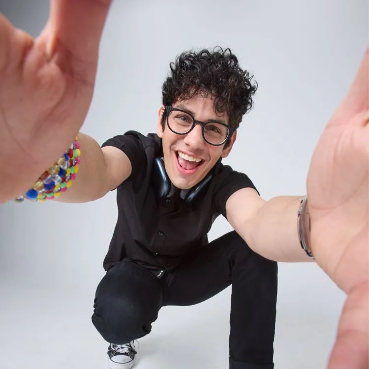 Image of Matt Bennett, crouching down with hands extended towards camera