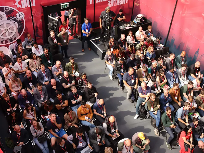A large audience seated in rows at Big Data, viewed from above, with a mix of men and women wearing conference badges.