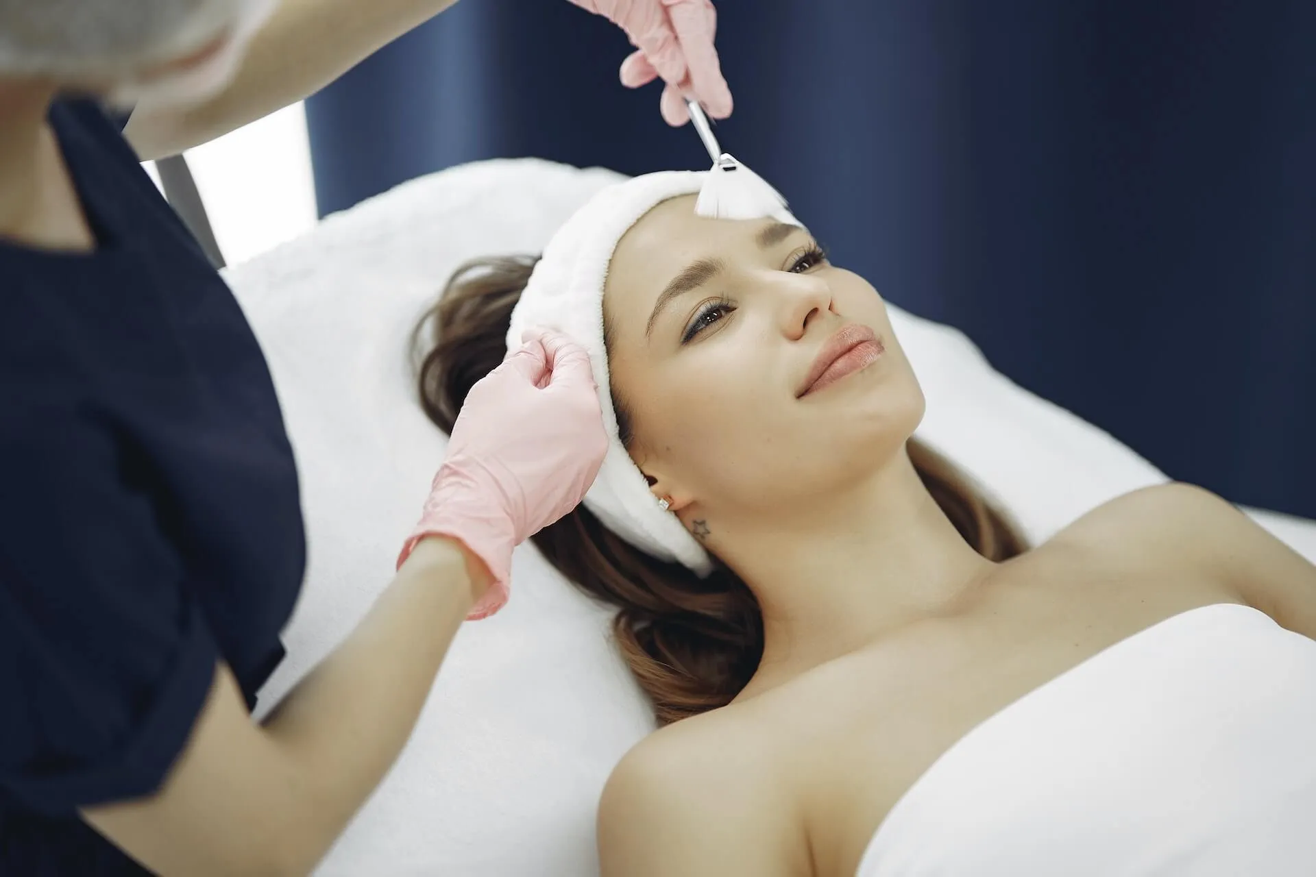 A relaxed client receiving the hydrating Blue Lagoon facial in a serene spa setting.