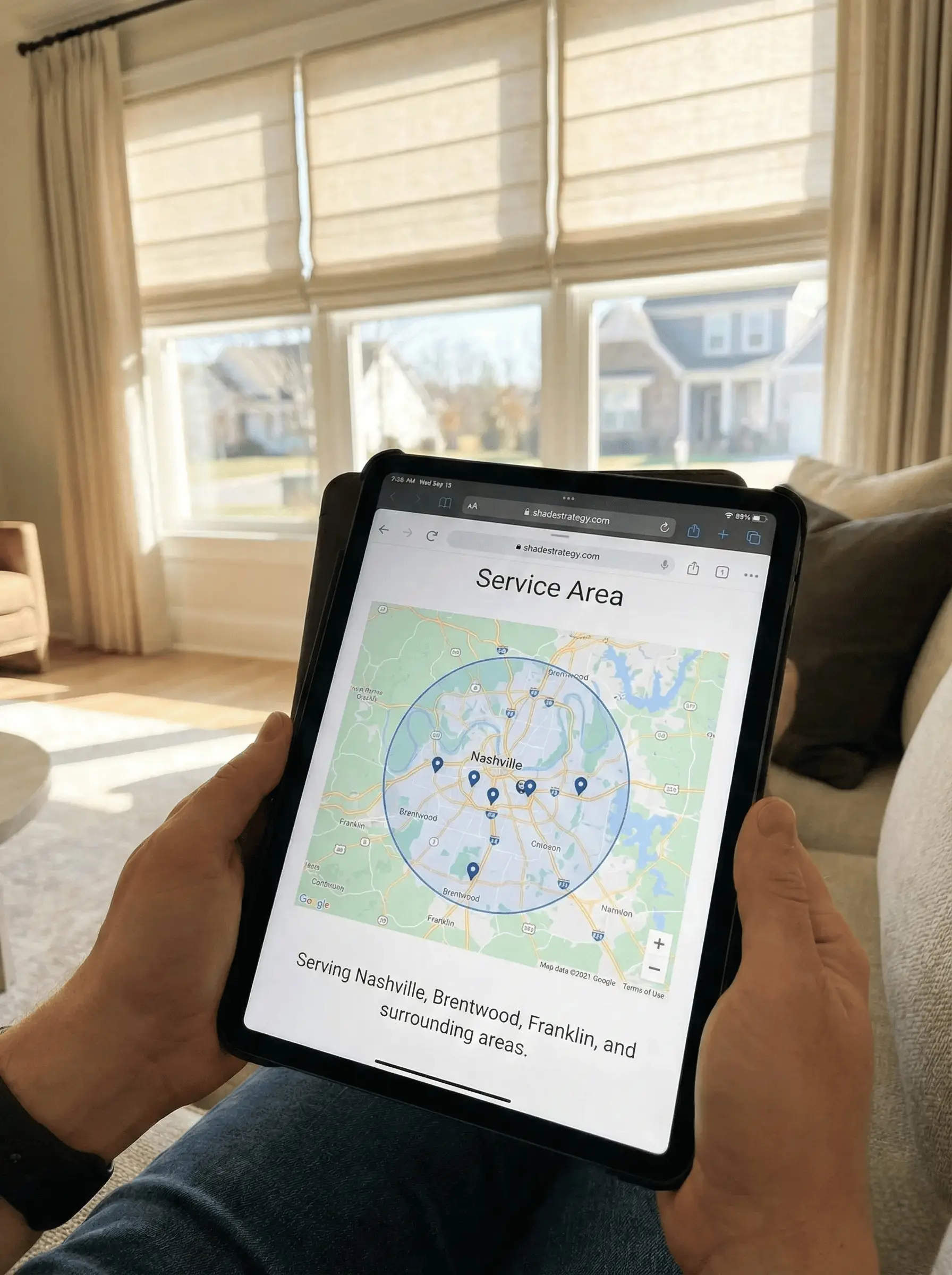 Person holding a tablet displaying a service area map centered on Nashville with a blue radius circle and pins for Brentwood, Franklin, and surrounding areas.