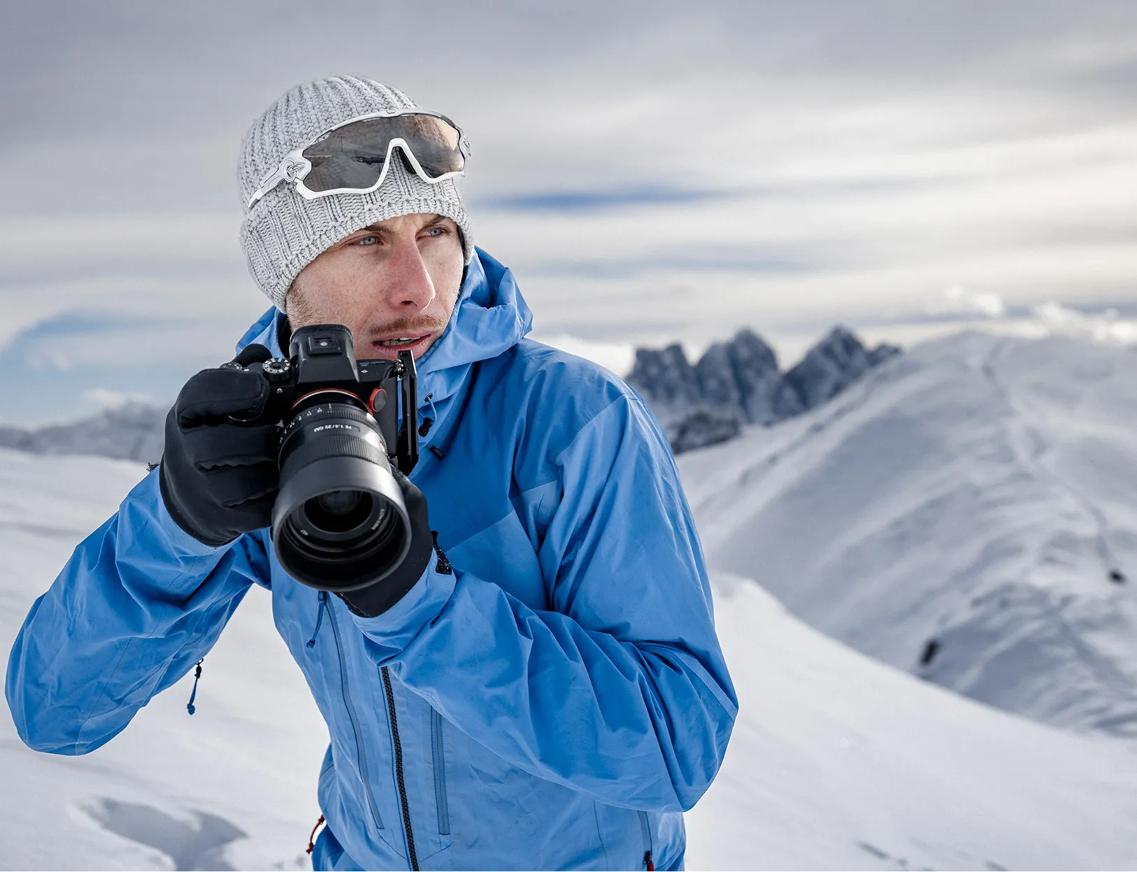 Stefan Santifaller standing in the Dolomites shooting with his camera