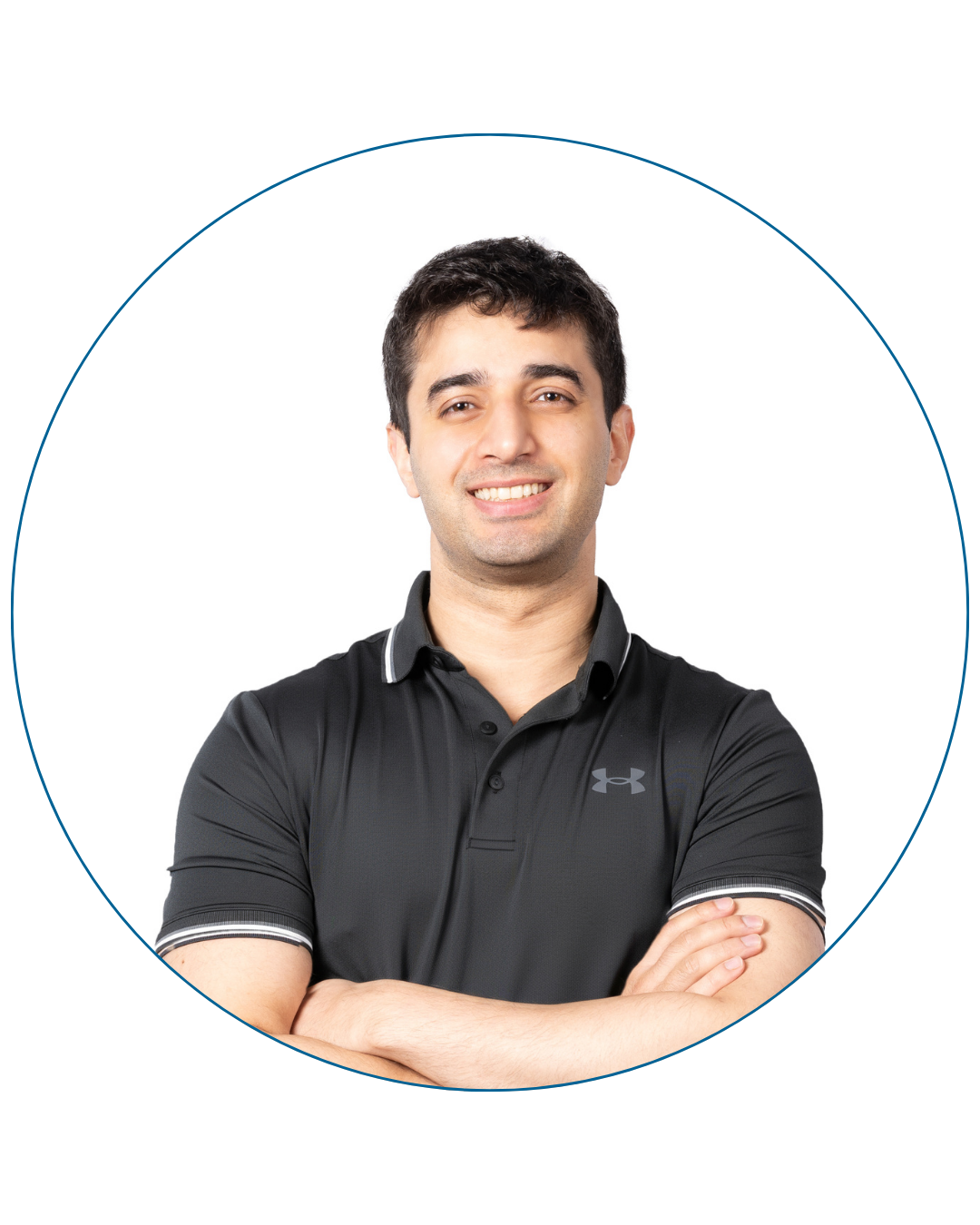 Smiling man with short dark hair wearing a black Under Armour polo shirt, arms crossed.