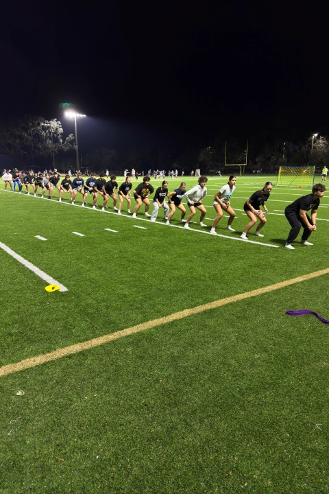 A line of people standing on a football field at Mega Athletics in Fish Hawk, FL.