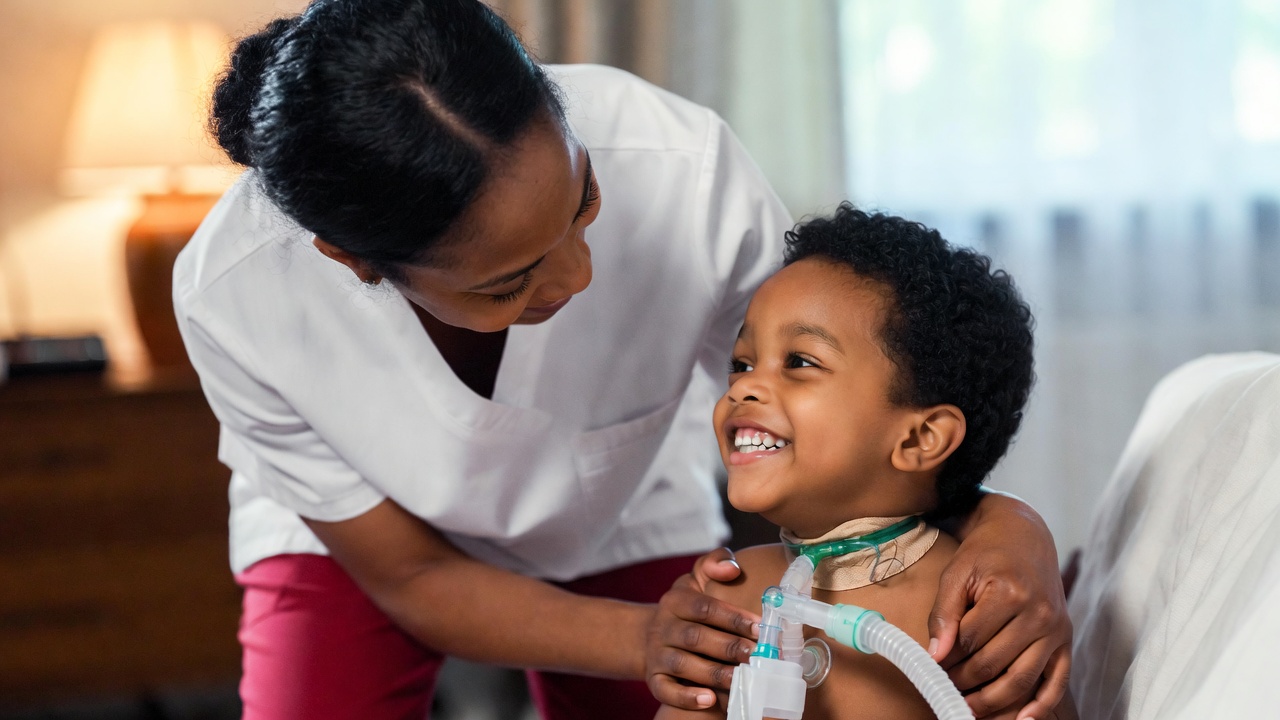 IntelliChoice private duty nurse caring for a smiling child with a trach and ventilator at home