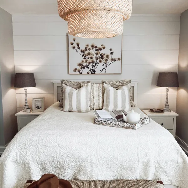 Bed with rattan light hanging over