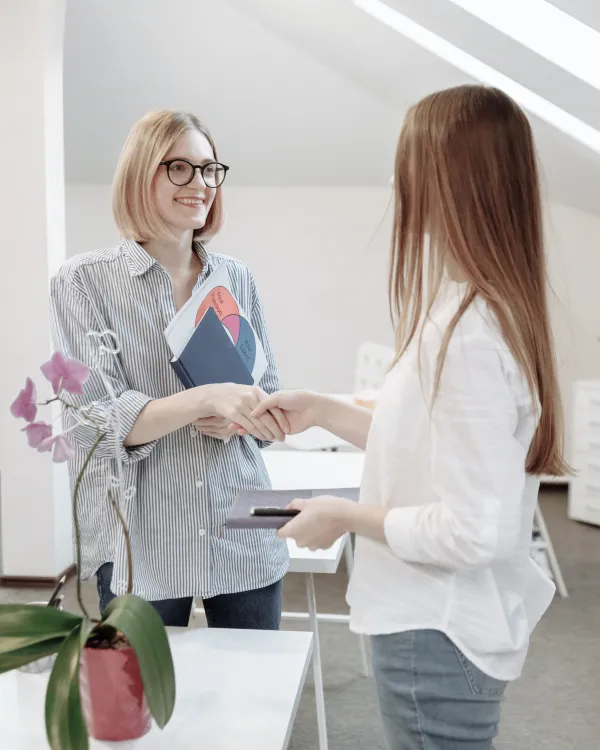 Two women shaking hands