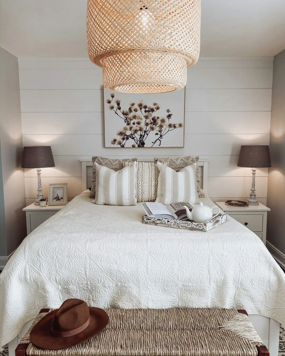 Bed with rattan light hanging over