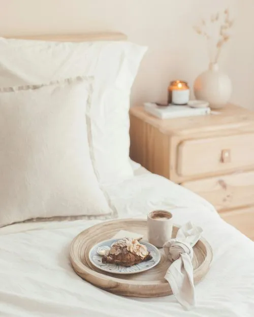 Bed with pillows and tray with food